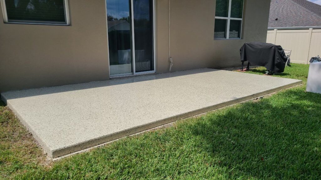 Light flake coating on a raised back patio