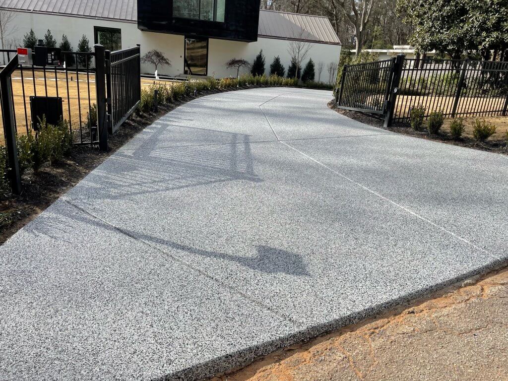 Long curved gray flake epoxy driveway