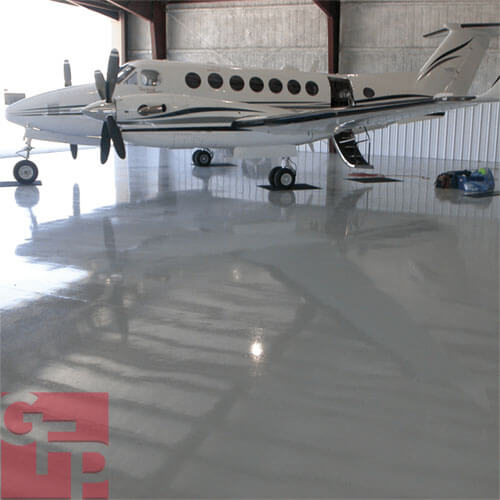 Commercial Hangar Epoxy Flooring with White Airplane