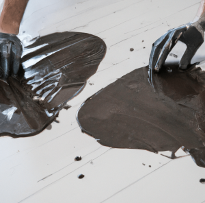 paint spilled on floor and all over hands